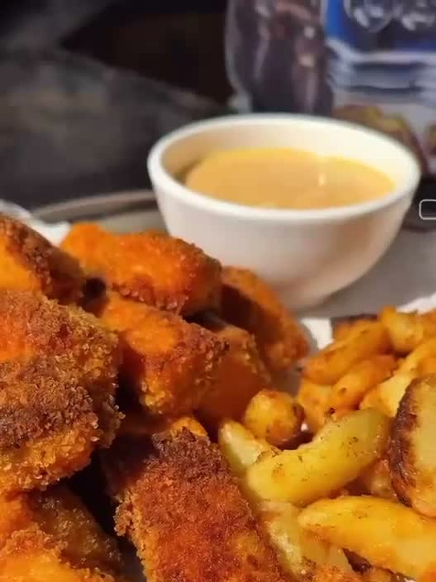 Crispy nuggets and fries with dipping sauce